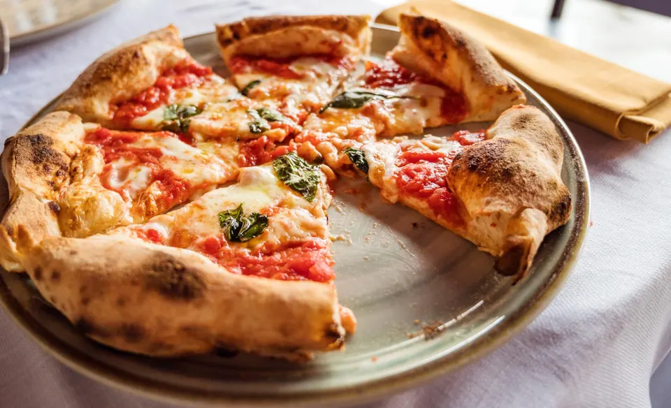 A classic Margherita pizza with fresh basil and melted mozzarella from The Pizza Oven