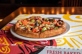 Wood-fired pizza oven with roaring flames at The Pizza Oven New York